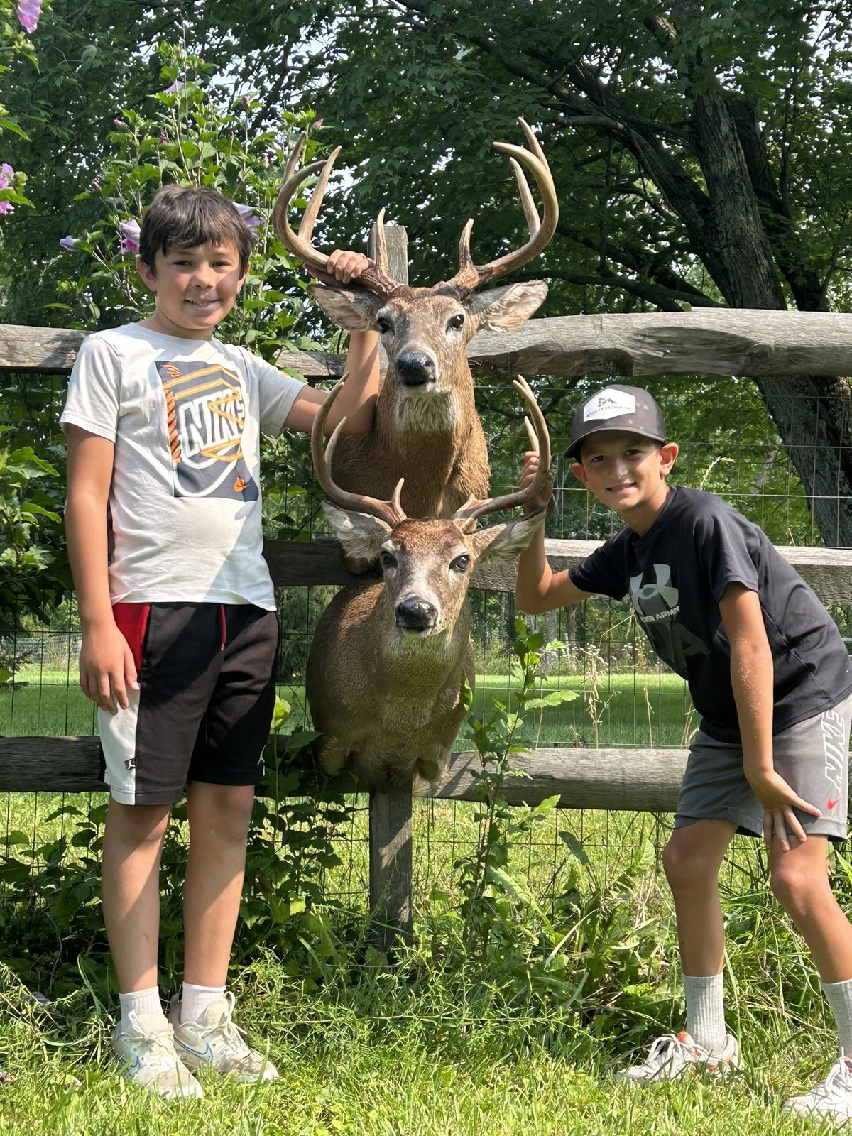Two young hunters with their whitetail shoulder mounts by K-J Creations